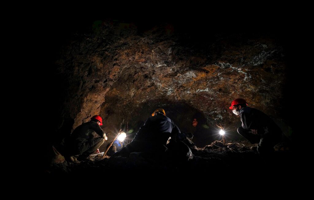 pexels photo 13658087 13658087 Adventurers exploring a cave in Iran at night with headlamps and hard hats.